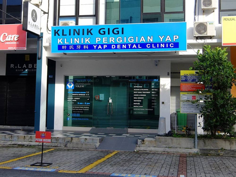 The shopfront of a dental clinic in Bukit Indah, Johor, with signage in English and Chinese