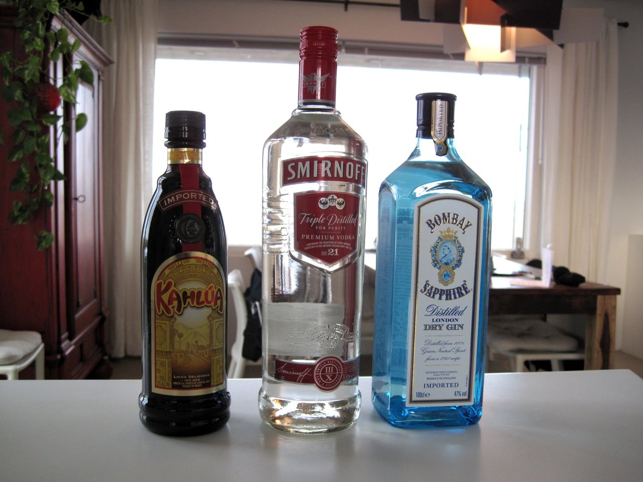 Duty-free shopping bottles of Kahlua, Smirnoff vodka, and Bombay Sapphire gin