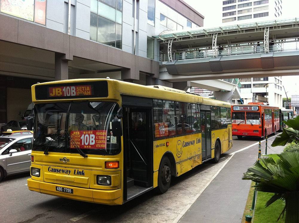 A yellow Causeway Link city bus on a Johor Bahru street