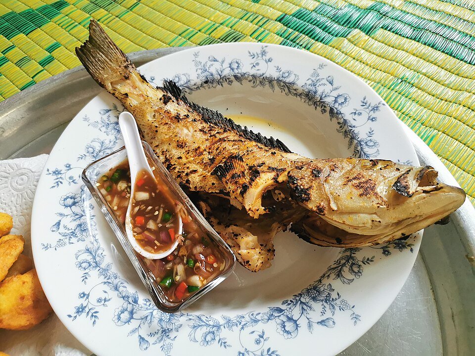 grilled sambal stingray on banana leaf at night seafood
