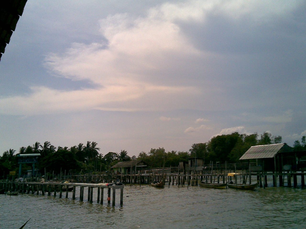Wooden fishing jetties and boats on stilts at Kampung Serkat, Tanjung Piai, in Pontian, Johor