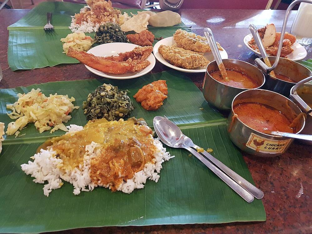 Banana leaf rice served on a banana leaf with several curries and side dishes