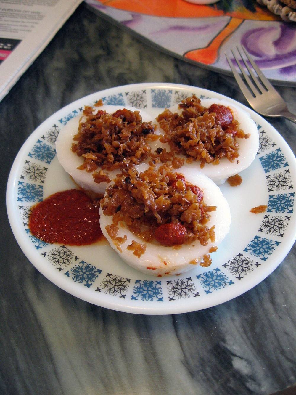 Steamed rice cakes topped with preserved radish and chilli, known as chwee kueh