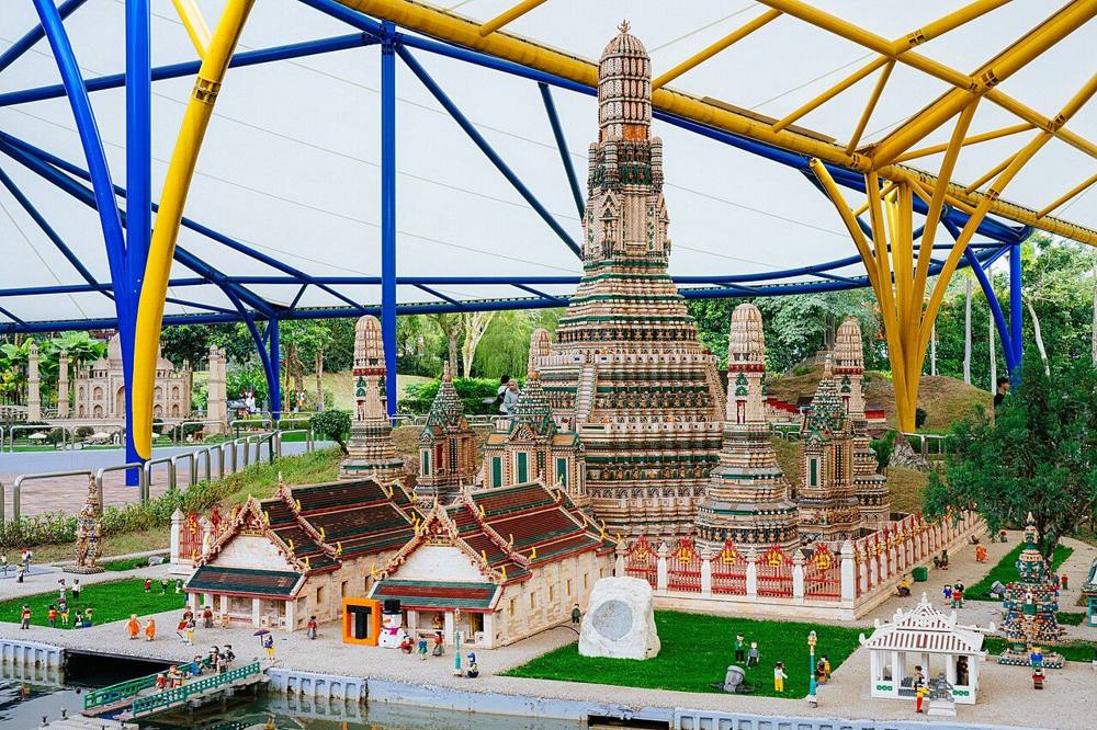 A detailed LEGO brick model of a Thai-style temple tower in Miniland at LEGOLAND Malaysia, under a white canopy