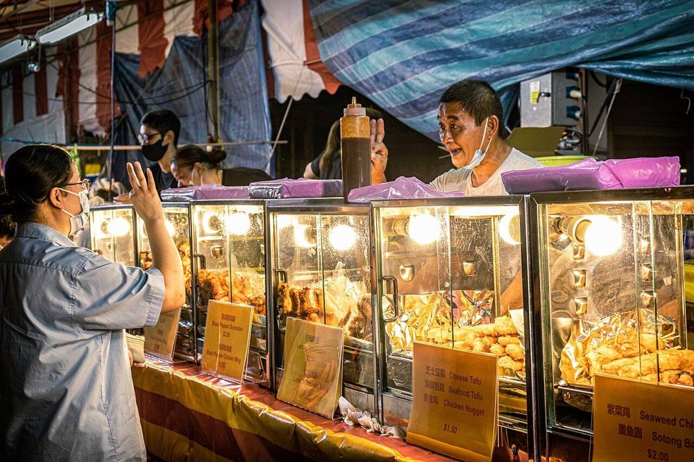 Food stalls at a Malaysian pasar malam with traditional Malay dishes on sale